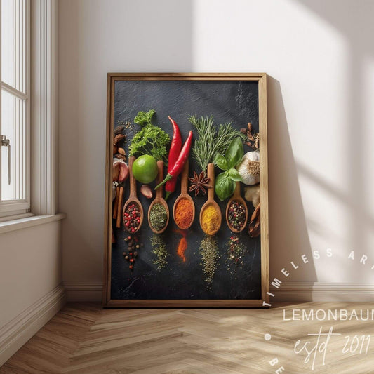 A framed vertical art print leaning against a white wall on a wood herringbone floor, showing a colorful arrangement of spices in wooden spoons with vegetables on a dark background. The print is branded with a watermark 'Lemonbaum'.